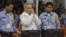 FILE - Former Khmer Rouge S-21 prison chief Duch (C) greets the court during his appeal hearing at the Court Room of the Extraordinary Chambers in the Courts of Cambodia (ECCC) on the outskirts of Phnom Penh, Feb. 3, 2012. 