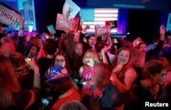 Supporters of Republican Florida Governor Ron DeSantis react to a television network declaring DeSantis the winner during his 2022 U.S. midterm elections night party in Tampa, Florida, Nov. 8, 2022.