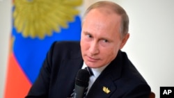 Russian President Vladimir Putin speaks to Russian journalists during a news conference following the BRICS summit in Goa, India, Oct. 16, 2016. Putin is denying allegations of Russian government interference with the U.S. election process.
