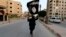 A militant loyal to the Islamic State in Iraq and the Levant (ISIL) waves an ISIL flag in Raqqa, Syria, June 29, 2014. 