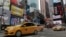 FILE — New York City taxis pass through New York's Times Square.