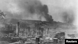 Smoke rises from the ruins of African Americans' homes following the race massacre in Tulsa, Oklahoma in 1921. (Library of Congress via Reuters)