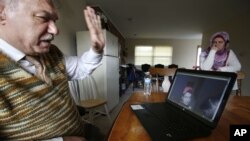 Rifat Moustafa, a Syrian immigrant, greets his 16-year-old son, Hasib Moustafa Rifat, living in the Middle East, during a video chat at his home in Columbus, Ohio, Feb. 22, 2018. Hasib has been waiting in the Middle East for 18 months to get a U.S. visa.