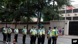 Chinese police officers form up in front of the United States Consulate in Chengdu in southwestern China's Sichuan province, July 25, 2020.