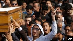 Relatives and colleagues of Mohammed Reda, 19, an Egyptian student who was killed Thursday during clashes with security forces near Cairo University, chant slogans as they carry a coffin following Friday prayers in Cairo, Egypt, Friday, Nov. 29, 2013.