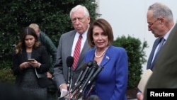 U.S. House Speaker Nancy Pelosi (D-CA) walks out with Senate Minority Leader Chuck Schumer (D-NY) and House Majority Leader Steny Hoyer (D-MD) to speak with reporters after meeting with President Trump at the White House in Washington, Oct. 16, 2019.