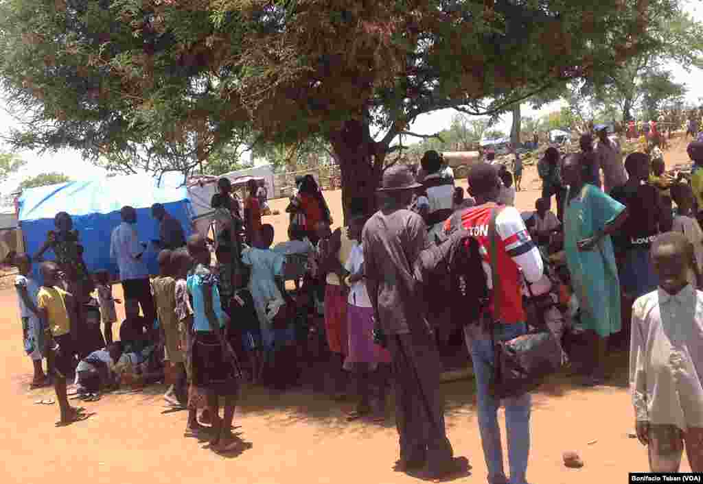 South Sudanese wait in line to register as refugees in Uganda after arriving at Ayilo refugee resettlement camp.