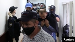 Ivan Safronov, a former journalist who works as an aide to the head of Russia's space agency Roscosmos, detained on suspicion of treason is escorted before a court hearing in Moscow, Russia, July 7, 2020. 