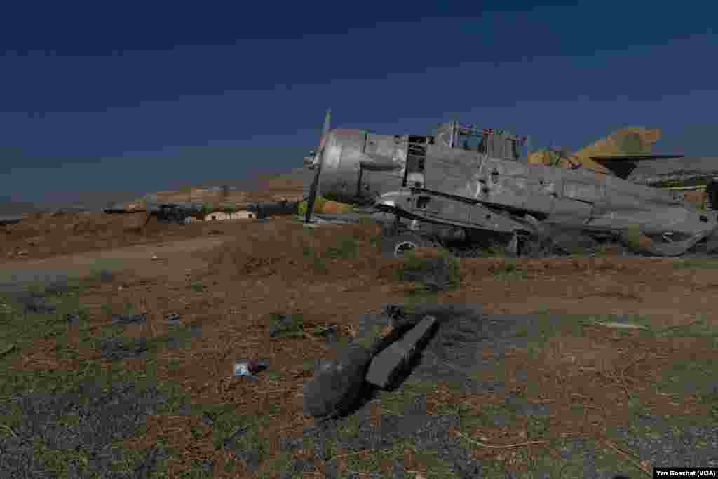 Airplanes that were destroyed by the Israeli airstrikes in the Mazzeh air base are still scattered near the airstrip, in Damascus, on Dec. 19, 2024. (Yan Boechat/VOA)
