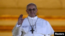 Newly elected Pope Francis, Cardinal Jorge Mario Bergoglio of Argentina appears on the balcony of St. Peter's Basilica after being elected by the conclave of cardinals, at the Vatican, March 13, 2013.