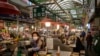 A vendor waits for customers at a market in Seoul on April 20, 2020. 