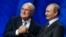 FILE - Now suspended FIFA President Sepp Blatter (L) shakes hands with Russian President Vladimir Putin during the preliminary draw for the 2018 FIFA World Cup at Konstantin Palace in St. Petersburg, July 25, 2015.
