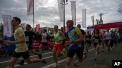 Ukrainians participate in a one-kilometer race in Kyiv, Ukraine, Oct. 29, 2023.