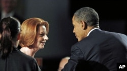 U.S. President Barack Obama and Australian Prime Minister Julia Gillard talk during a parliamentary dinner at Parliament House in Canberra, Australia, November 16, 2011.