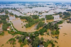 FILE - An aerial view shows the flooded Gu town following heavy rainfall in the region, in Luan, Anhui province, China, July 20, 2020.