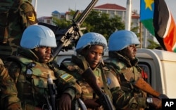 U.N. peacekeepers from Rwanda wait to escort members of the U.N. Security Council as they arrive at the airport in Juba, South Sudan, Sept. 2, 2016. The envoys arrived Friday to press the government to allow another 4,000 peacekeepers into South Sudan.