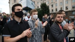 People applaud during a protest rally against the removal of opposition candidates from the presidential elections in Minsk, Belarus, July 14, 2020.