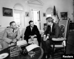 President Kennedy, right, meets with Secretary of Defense Robert S. McNamara and Chairman of the Joint Chiefs of Staff General Maxwell D. Taylor, left, in the Oval Office at the White House on Oct. 2, 1963.