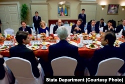 Kerry, back to camera, has a breakfast meeting with members of the American Chamber of Commerce in Kazakhstan, in Astana. Executive director Doris Bradbury is among the diners facing him.