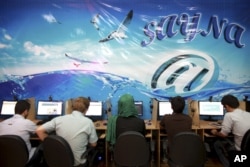 FILE - Iranians surf the internet at a cafe in Tehran.