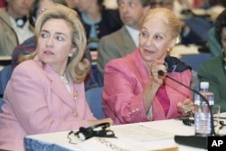 FILE - First lady Hillary Clinton and Leia Maria Boutros Boutros-Ghali, wife of U.N. Secretary General Boutros Boutros-Ghali, at a panel discussion on women's health and security at the U.N. Women's Conference in Beijing, Sept. 5, 1995.