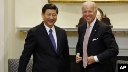 FILE - Joe Biden and China's Xi Jinping are pictured in the Roosevelt Room at the White House in Washington, Feb. 14, 2012, when each was his nation's vice president.