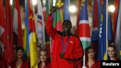 Men's marathon gold medallist Stephen Kiprotich of Uganda marches into closing ceremony of the London 2012 Olympic Games at the Olympic Stadium, August 12, 2012.