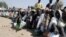 FILE - Internally displaced persons wait to be served with food at Dikwa camp, in northeast Nigeria's Borno state, Feb. 2, 2016.