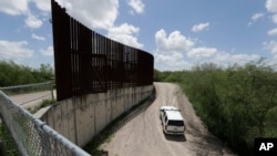 U.S. Customs and Border Patrol patrol along the border fence, June 27, 2018, in Hidalgo, Texas. 