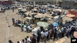 People queuing at the Nakasero polling station in the center of Kampala, Uganda, Friday, Feb. 18, 2011, as they wait to cast their vote
