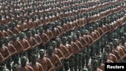 FILE - Indonesian army soldiers shout slogans as they run during a rehearsal for a ceremony marking the 70th anniversary of Indonesia's military in Cilegon, Banten province.