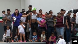 Migrants demand better conditions or that they be transferred to another center, at an immigration detention center in Tapachula, Chiapas State, Mexico, April 26, 2019.
