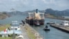 FILE - Cargo vessels transit through the Panama Canal, on the outskirts of Panama City, Panama, April 19, 2023.