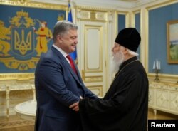 Ukraine's President Petro Poroshenko, left, meets with Patriarch Filaret, head of the Ukrainian Orthodox Church of the Kyiv Patriarchate, in Kyiv, Ukraine, Oct. 11, 2018.