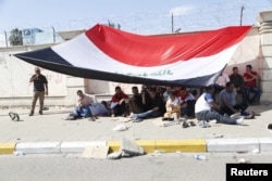 Supporters of prominent Iraqi Shi'ite cleric Muqtada al-Sadr hold a sit-in in the streets near the gates of Baghdad's heavily fortified Green Zone, March 18, 2016.