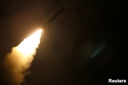 The U.S. Navy guided-missile cruiser USS Monterey fires a Tomahawk land attack missile April 14, 2018.