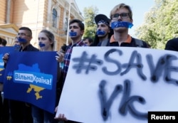 People hold placards during a protest against a ban of Russian social networks Vkontakte by the Ukrainian government, in Kiev, Ukraine, May 19, 2017.