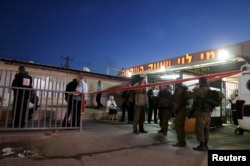 Israeli troops gather near a supermarket that was the scene of a stabbing near the West Bank city of Ramallah, Feb. 18, 2016.
