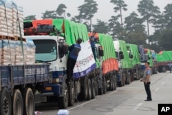 FILE - South Korean trucks with food aid prepare to leave for North Korean city of Kaesong in Paju, South Korea, Sept. 21, 2012.