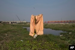 FILE - A temporary toilet made by farmers for their use is seen near the River Yamuna in New Delhi, India, Nov. 19, 2015.