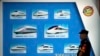 FILE - A security official stands near a display showing different models of Chinese trains at a maintenance yard during a media tour ahead of the 2018 Forum on China-Africa Cooperation in Beijing, Aug. 30, 2018. This year's forum is set for Sept. 5-6. 