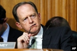 Sen. Patrick Toomey, R-Penn., listens to Secretary of Commerce Wilbur Ross during a Senate Finance Committee hearing on tariffs, June 20, 2018, in Washington.