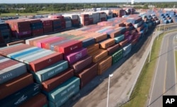 China Shipping Company and other containers are stacked at the Virginia International's terminal in Portsmouth, Va., May 10, 2019.