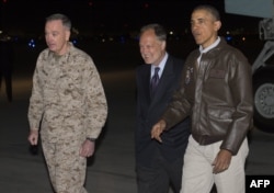 U.S. President Barack Obama greets U.S. Ambassador to Afghanistan James Cunningham (C) and Gen. Joseph Dunfore, Commander of ISAF and U.S. Forces Afghanistan, during a surprise visit to the troops at Bagram Air Field, Kabul, Afghanistan, May 25, 2014.