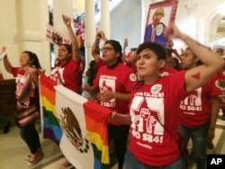 FILE - Demonstrators march in the Texas Capitol, May 29, 2017, protesting the state's anti-sanctuary cities bill, in Austin, Texas.