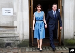 Britain's Prime Minister David Cameron and his wife Samantha leave after voting in the EU referendum in London, Thursday, June 23, 2016.