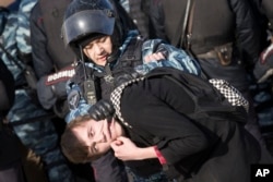 Police detain a protester in downtown Moscow, March 26, 2017.