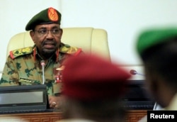 FILE - Sudan's President Omar al-Bashir is seen during a swearing-in ceremony of new officials after he dissolved the central and state governments in Khartoum, Sudan, Feb. 24, 2019.