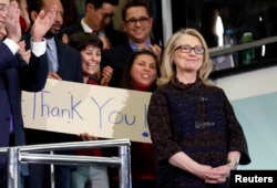 FILE - U.S. Secretary of State Hillary Clinton receives applause upon her departure from her last day in office at the State Department in Washington, D.C., Feb. 1, 2013.