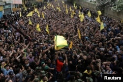 Hezbollah members carry the coffin of top Hezbollah commander Mustafa Badreddine, who was killed in an attack in Syria, during his funeral in Beirut&#39;s southern suburbs, Lebanon, May 13, 2016.